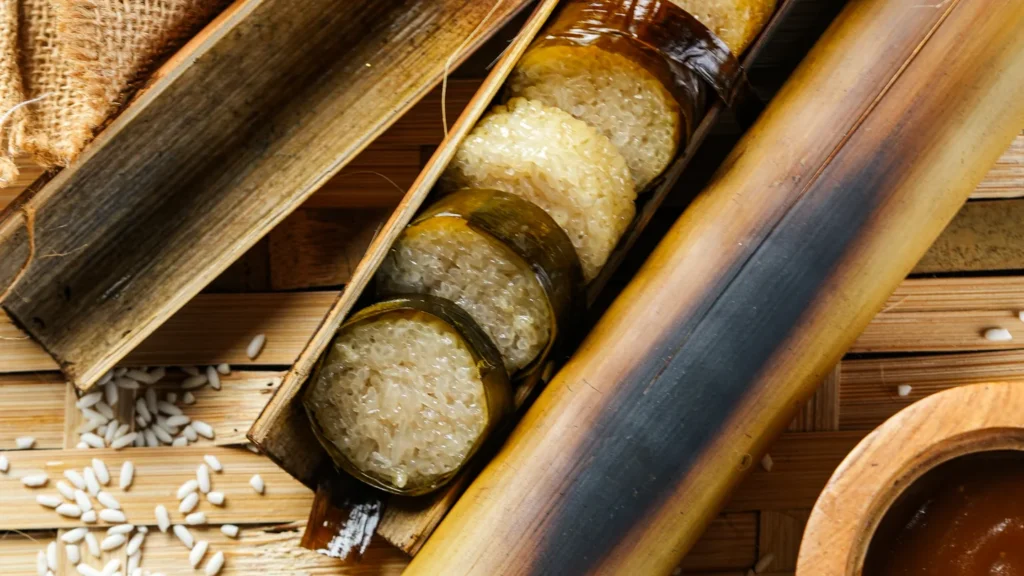 Sliced sticky rice roasted in bamboo on a woven mat